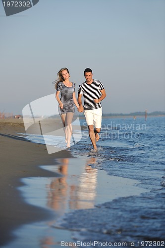 Image of happy young couple have romantic time on beach