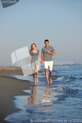 Image of happy young couple have romantic time on beach