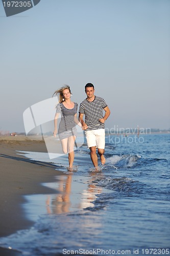 Image of happy young couple have romantic time on beach