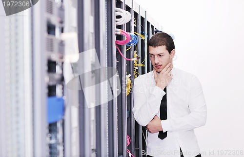 Image of young it engeneer in datacenter server room