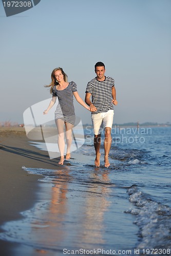 Image of happy young couple have romantic time on beach