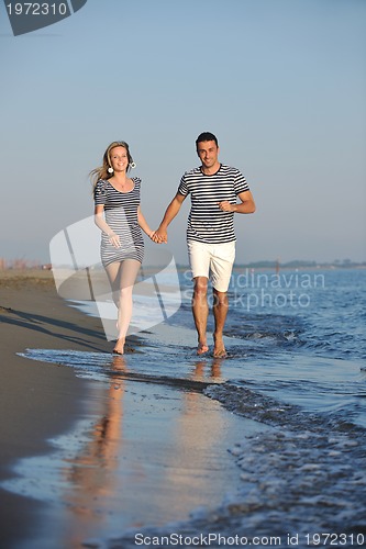 Image of happy young couple have romantic time on beach