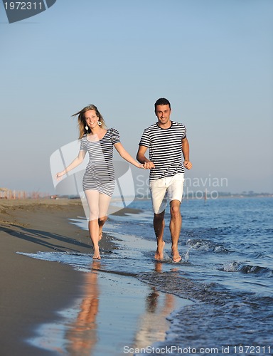 Image of happy young couple have romantic time on beach