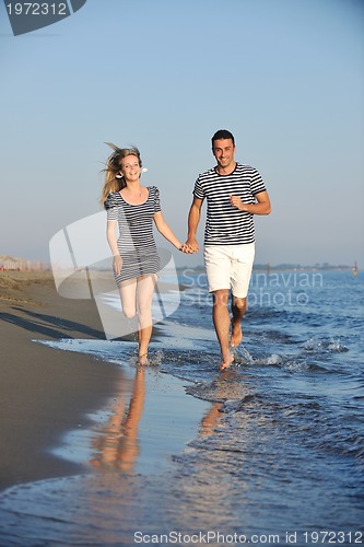 Image of happy young couple have romantic time on beach