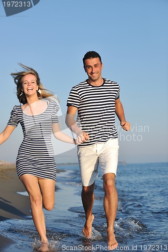 Image of happy young couple have romantic time on beach