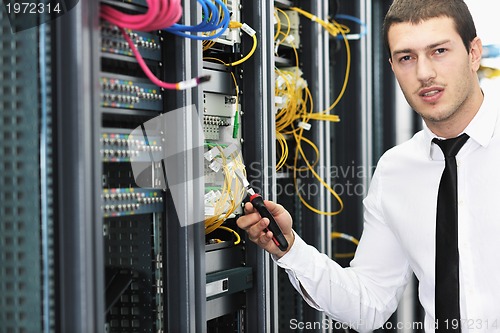 Image of young it engeneer in datacenter server room