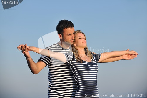 Image of happy young couple have romantic time on beach