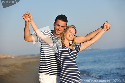 Image of happy young couple have romantic time on beach