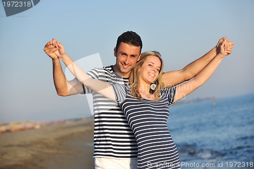 Image of happy young couple have romantic time on beach