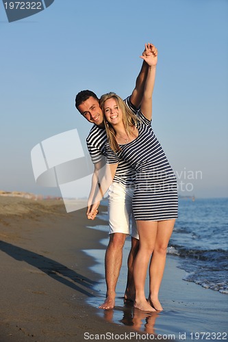 Image of happy young couple have romantic time on beach