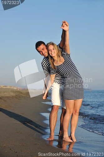 Image of happy young couple have romantic time on beach