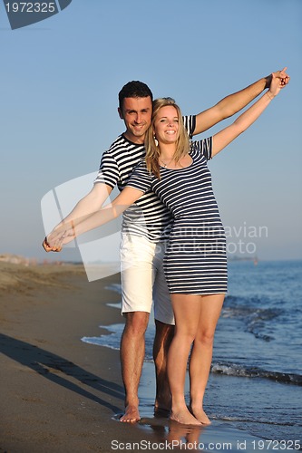 Image of happy young couple have romantic time on beach