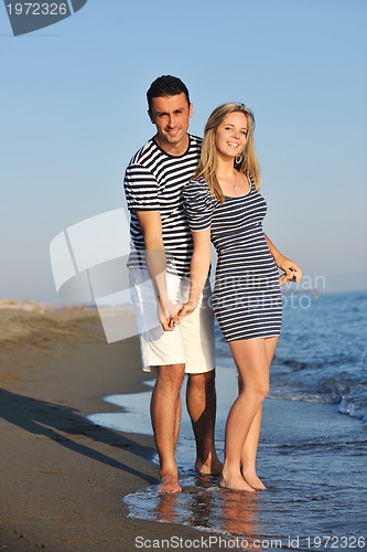 Image of happy young couple have romantic time on beach