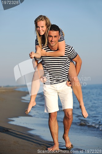 Image of happy young couple have romantic time on beach