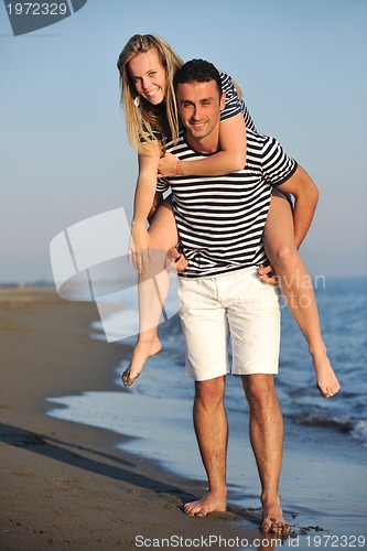 Image of happy young couple have romantic time on beach