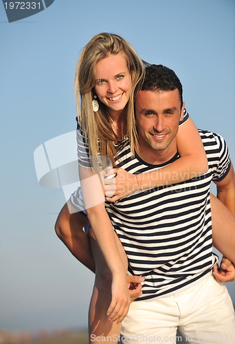 Image of happy young couple have romantic time on beach