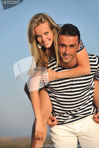 Image of happy young couple have romantic time on beach