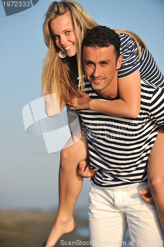 Image of happy young couple have romantic time on beach