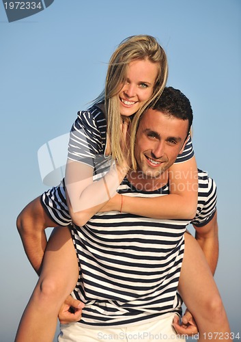 Image of happy young couple have romantic time on beach
