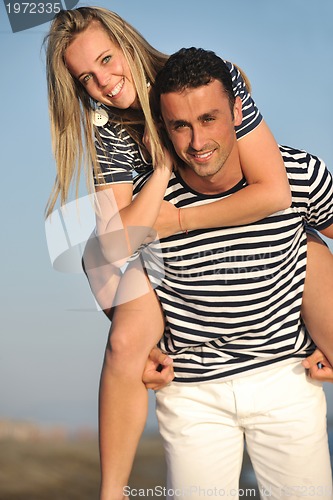 Image of happy young couple have romantic time on beach