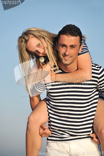 Image of happy young couple have romantic time on beach