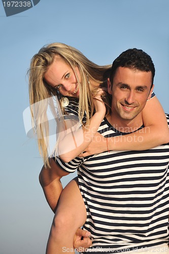 Image of happy young couple have romantic time on beach