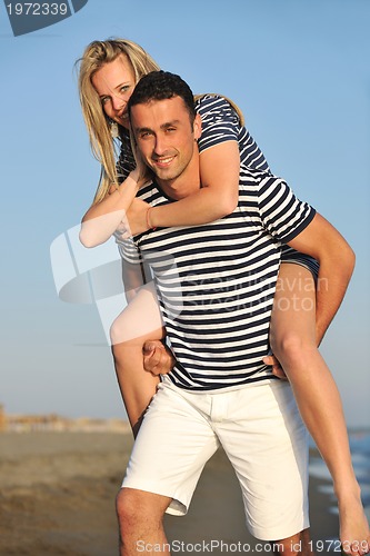 Image of happy young couple have romantic time on beach