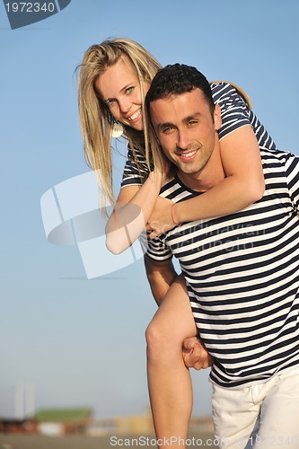 Image of happy young couple have romantic time on beach