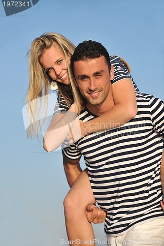 Image of happy young couple have romantic time on beach