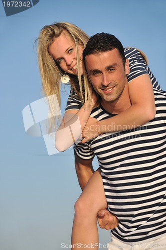 Image of happy young couple have romantic time on beach
