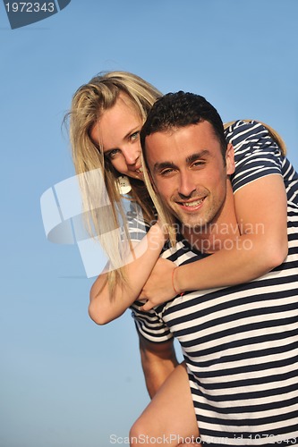Image of happy young couple have romantic time on beach