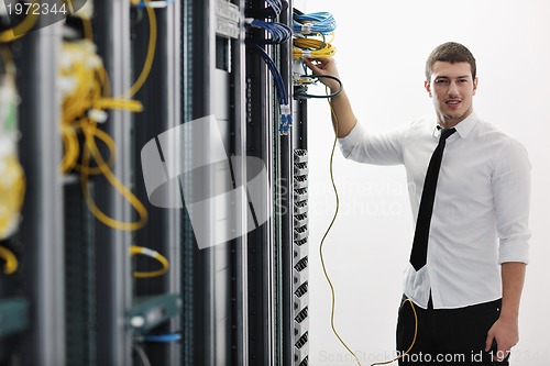 Image of young it engeneer in datacenter server room