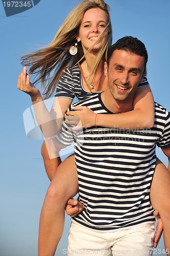 Image of happy young couple have romantic time on beach