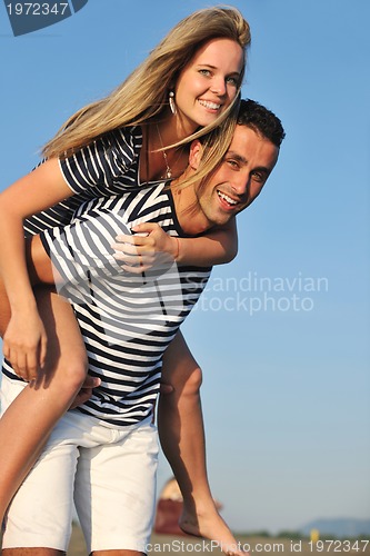 Image of happy young couple have romantic time on beach