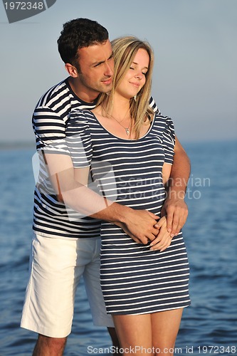 Image of happy young couple have romantic time on beach