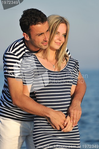 Image of happy young couple have romantic time on beach