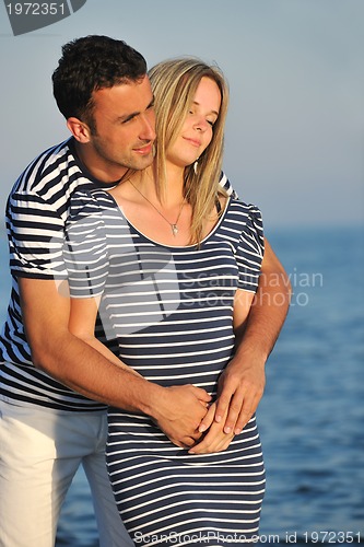 Image of happy young couple have romantic time on beach