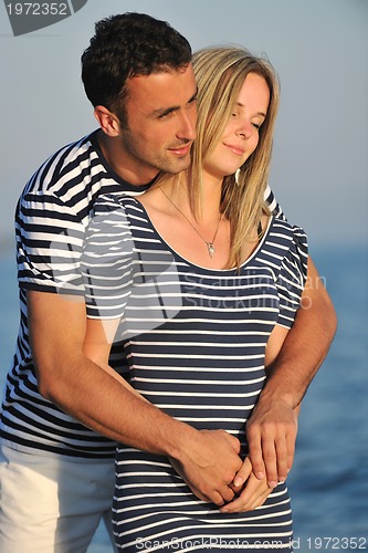 Image of happy young couple have romantic time on beach