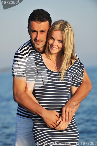 Image of happy young couple have romantic time on beach