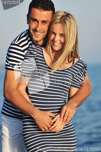 Image of happy young couple have romantic time on beach