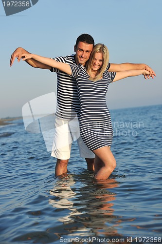 Image of happy young couple have romantic time on beach