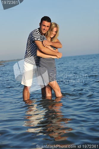 Image of happy young couple have romantic time on beach