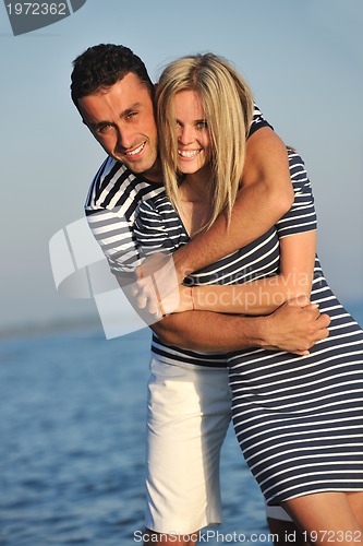 Image of happy young couple have romantic time on beach