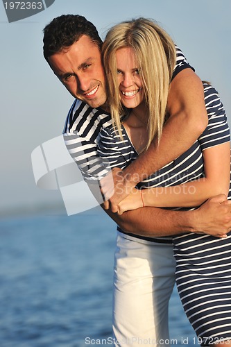 Image of happy young couple have romantic time on beach