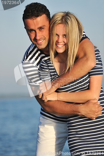 Image of happy young couple have romantic time on beach