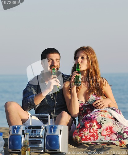 Image of happy young couple have romantic time on beach