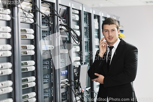 Image of young it engeneer in datacenter server room