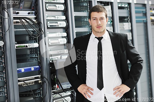 Image of young it engeneer in datacenter server room