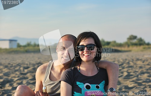 Image of happy young couple have fun on beach