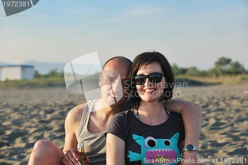 Image of happy young couple have fun on beach